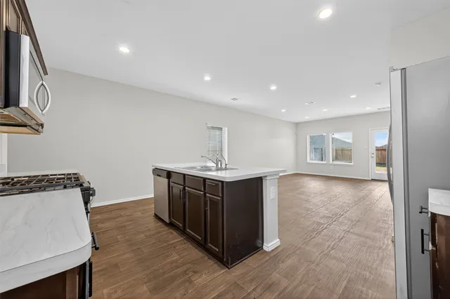 a kitchen with stainless steel appliances granite countertop a stove and a sink
