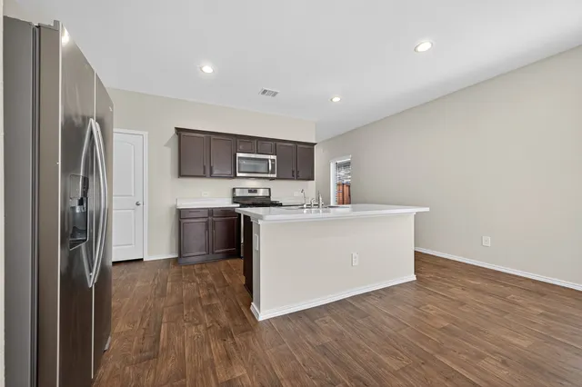 a kitchen with a refrigerator a stove top oven a sink and dishwasher