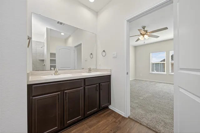 a bathroom with a double vanity sink and a mirror