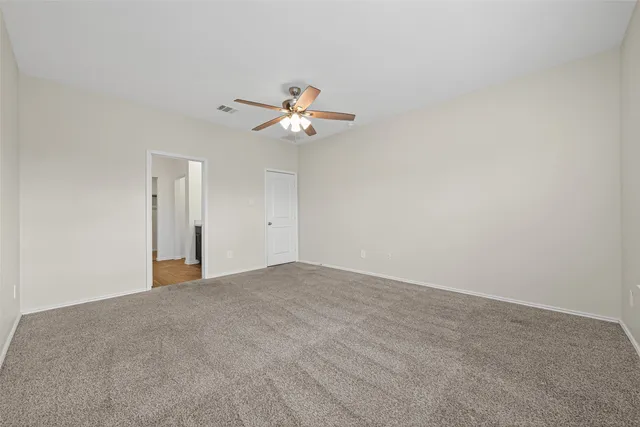 a view of an empty room with a fan