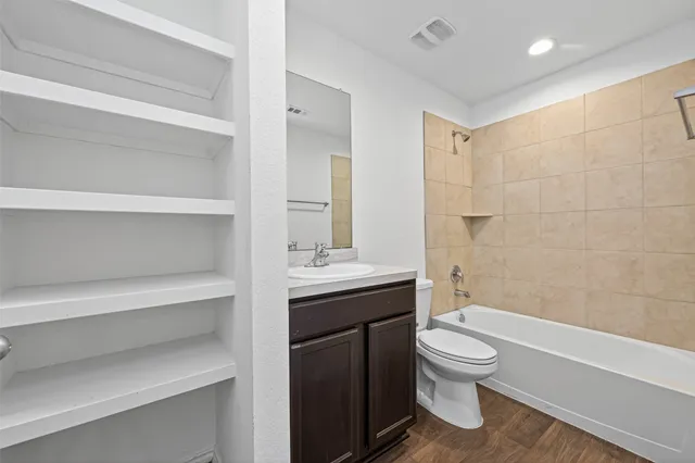 a bathroom with a toilet a sink and bathtub