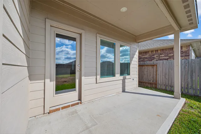 a view of backyard with large windows and a garage