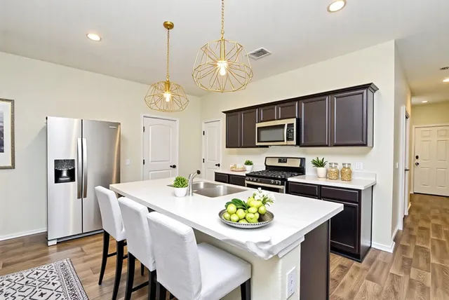 a kitchen with a dining table and chairs