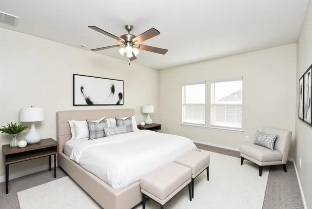 a bedroom with a bed and a couch