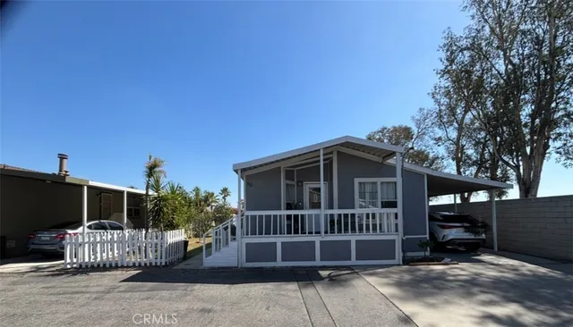 a view of a house with a deck in the backyard