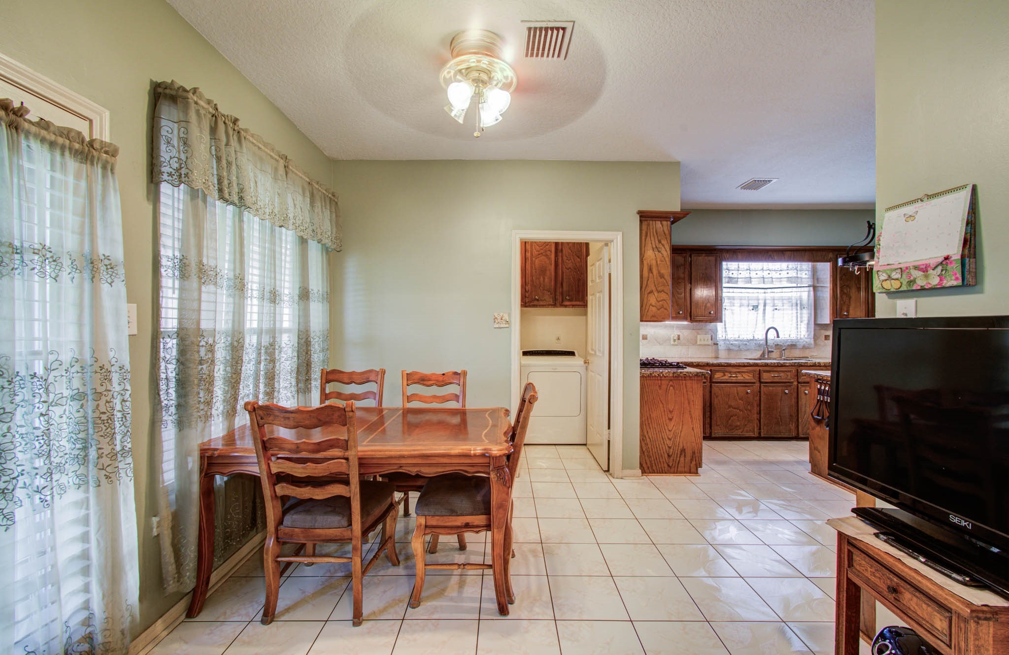 211 Squires Bend Stafford, TX 77477 - Photo 11 of 25 a view of a dining room with furniture and a kitchen