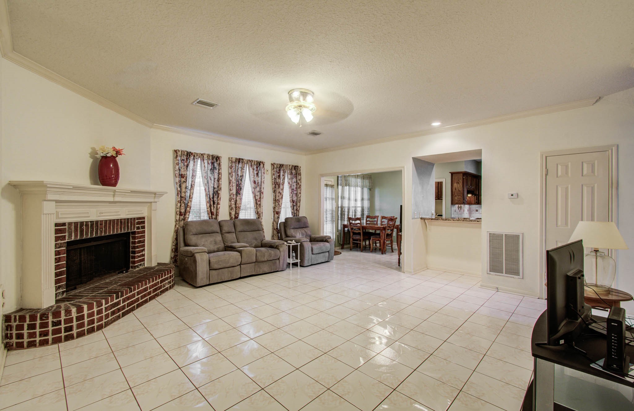 211 Squires Bend Stafford, TX 77477 - Photo 12 of 25 a living room with furniture and a fireplace