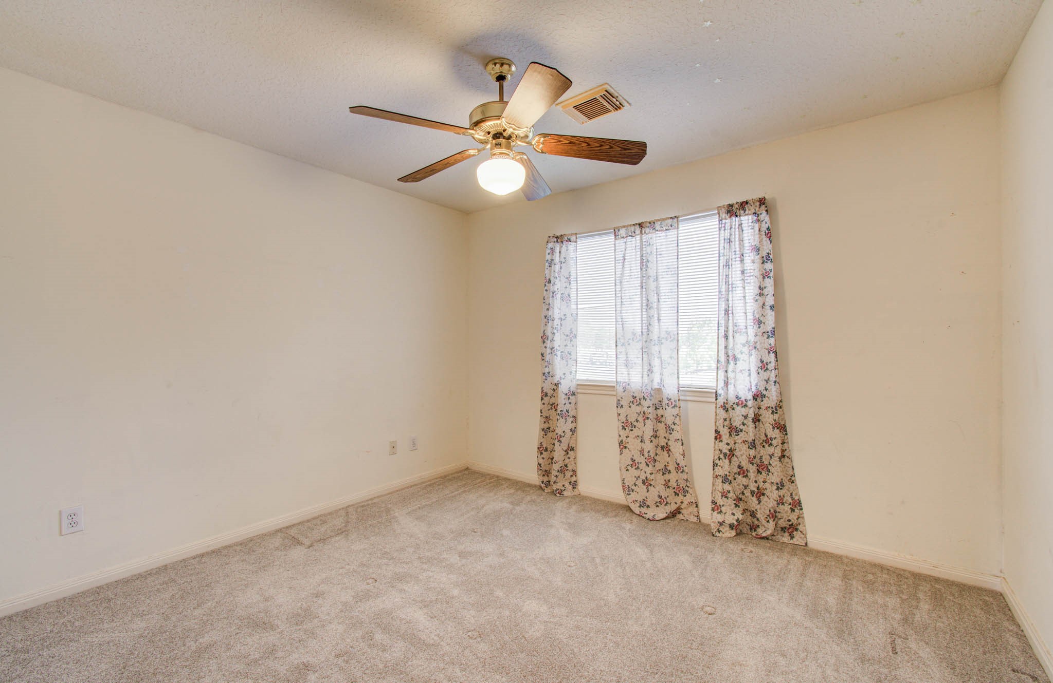 211 Squires Bend Stafford, TX 77477 - Photo 19 of 25 an empty room with windows and fan