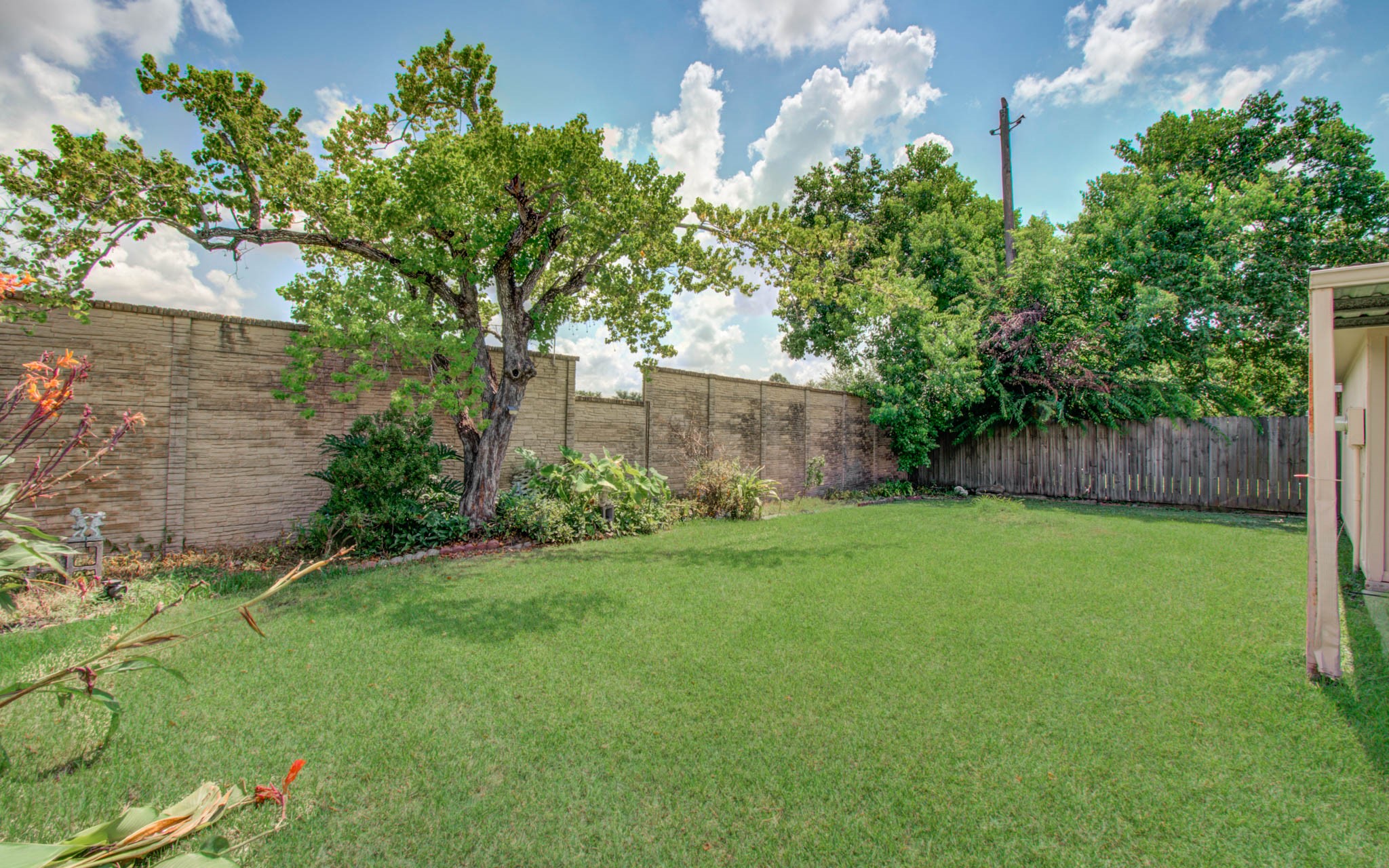 211 Squires Bend Stafford, TX 77477 - Photo 25 of 25 a view of a backyard with plants and large trees