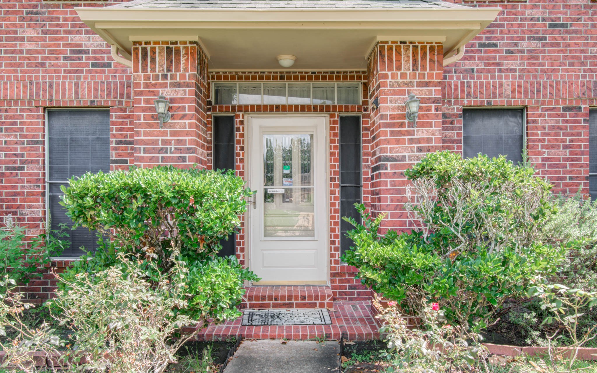 211 Squires Bend Stafford, TX 77477 - Photo 3 of 25 a front view of a house with a garden