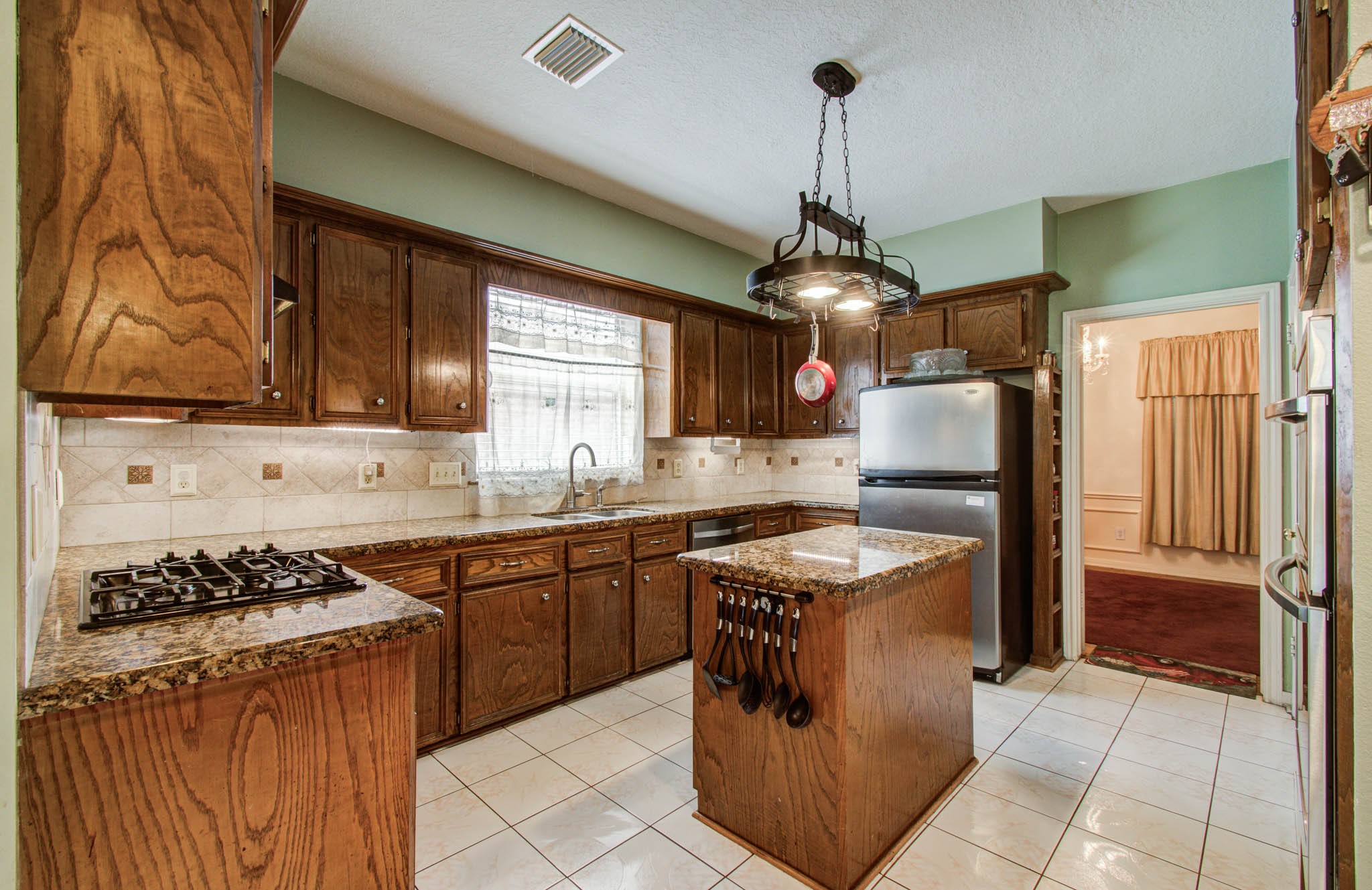 211 Squires Bend Stafford, TX 77477 - Photo 7 of 25 a kitchen with granite countertop a sink stove and refrigerator