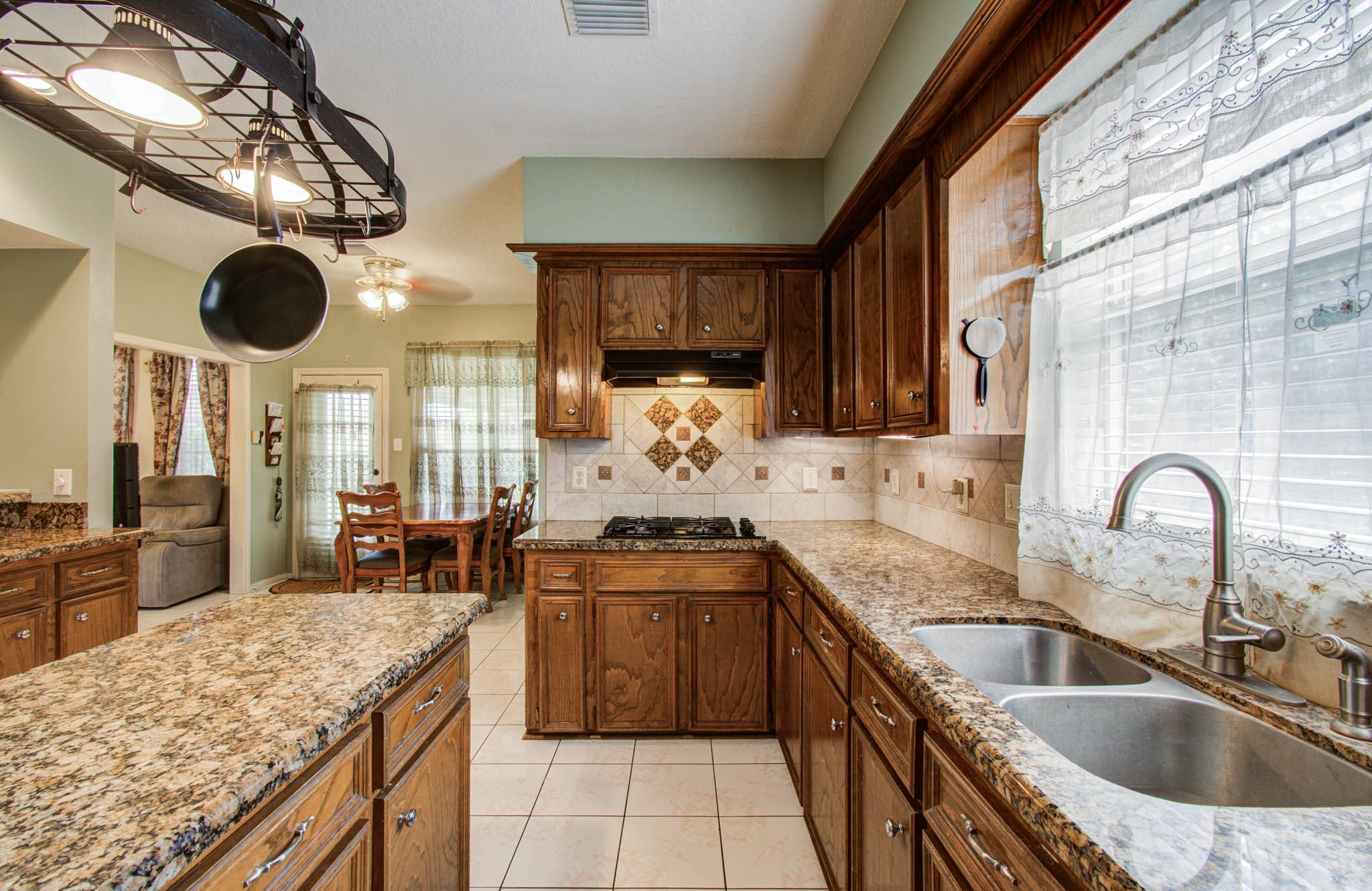 211 Squires Bend Stafford, TX 77477 - Photo 8 of 25 a kitchen with stainless steel appliances granite countertop a sink and a stove