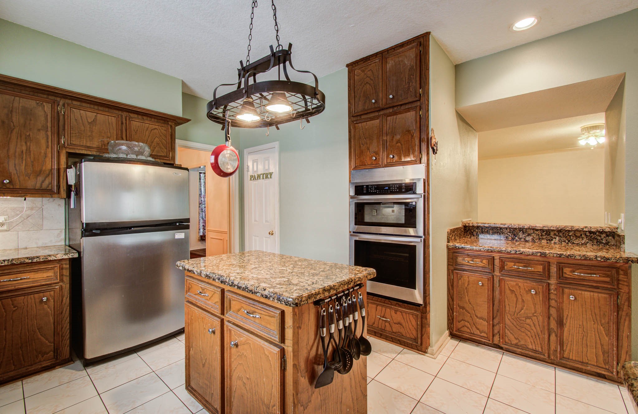 211 Squires Bend Stafford, TX 77477 - Photo 9 of 25 a kitchen with stainless steel appliances granite countertop a refrigerator and a stove top oven