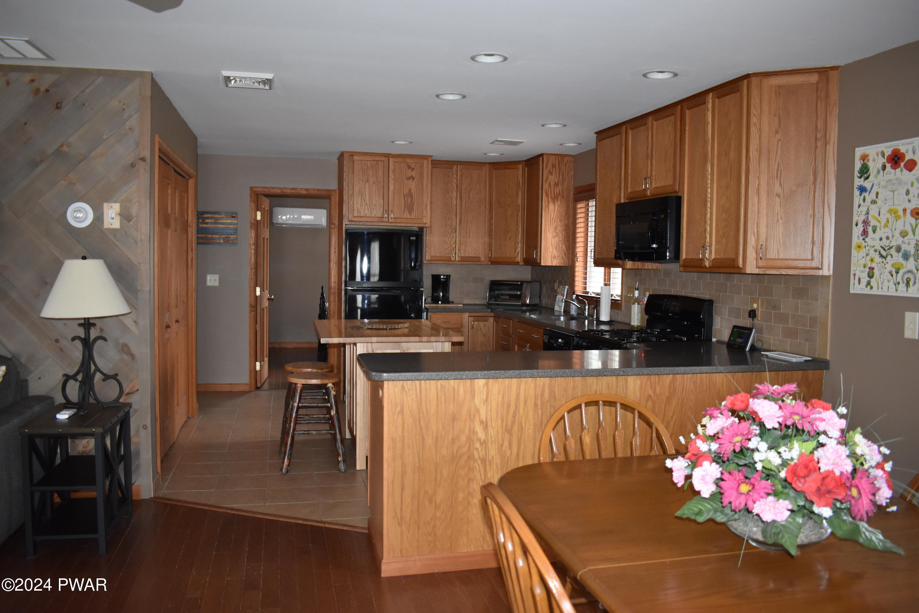 800 Rimrock Court Hawley, PA 18428 - Photo 10 of 30 a kitchen with granite countertop a sink dining table and chairs