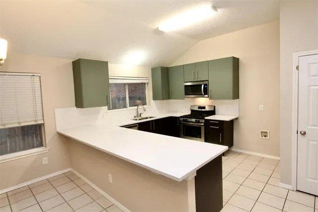 a kitchen with a sink and a stove top oven