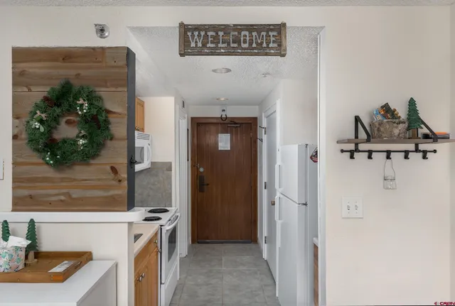 a view of a kitchen from the hallway