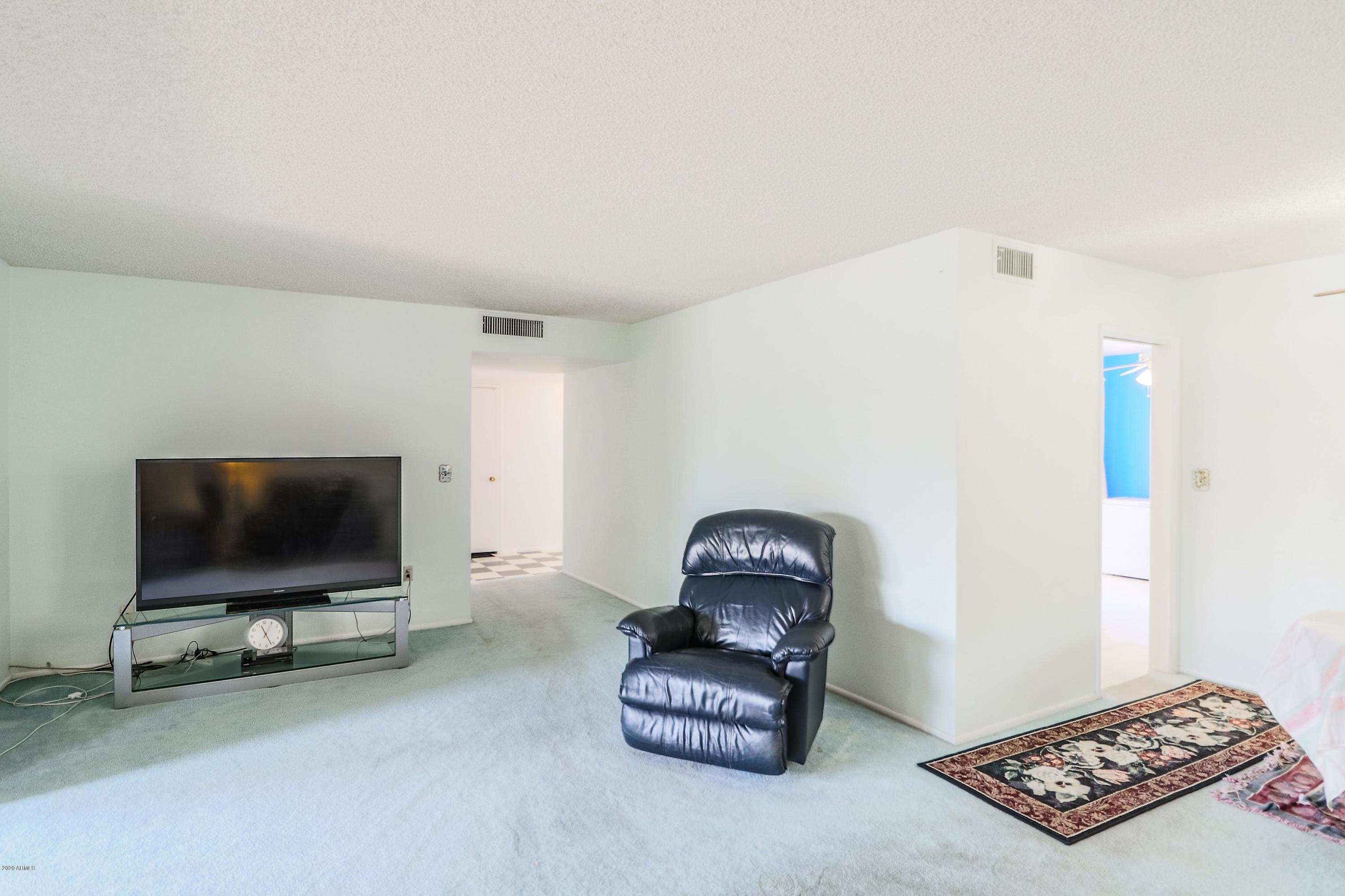 10101 West Mountain View Road Sun City, AZ 85351 - Photo 11 of 37 Living Room is Comfortably Carpeted