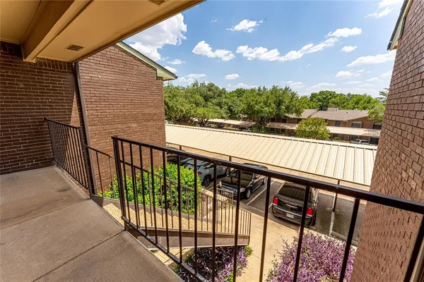 a view of balcony with wooden floor and fence