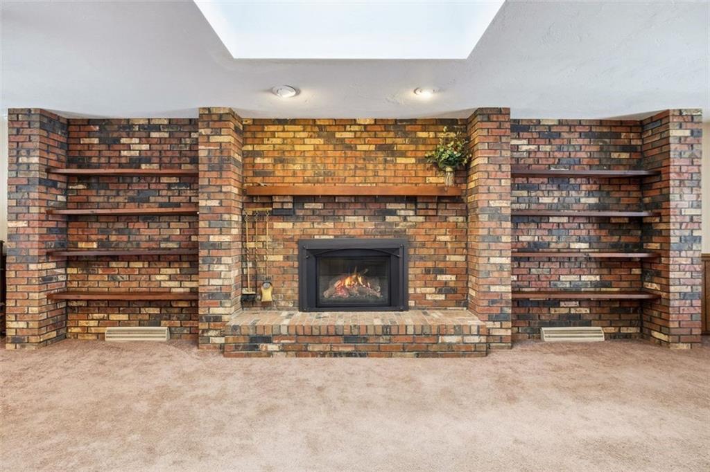 21 West Hillcrest Road Eighty Four, PA 15330 - Photo 27 of 48 The gorgeous masonry brick wall with built-in shelving frames the beautiful gas fireplace quite nicely.