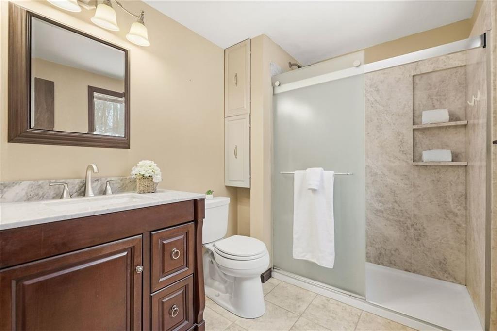 21 West Hillcrest Road Eighty Four, PA 15330 - Photo 35 of 48 The Primary Ensuite has been fully updated with walk-in tiled shower, built-in shelving and beautiful vanity.