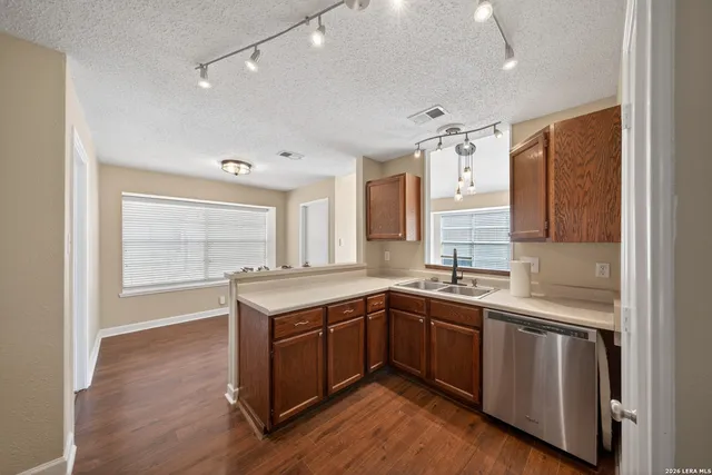 a kitchen with a sink stove and cabinets