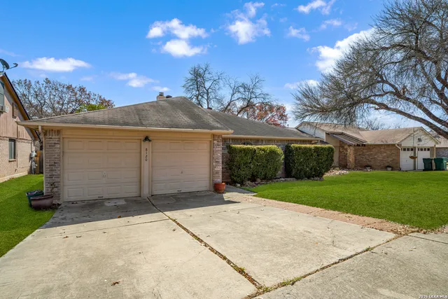 a view of a house with a yard and garage