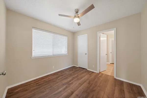 wooden floor in an empty room with a window