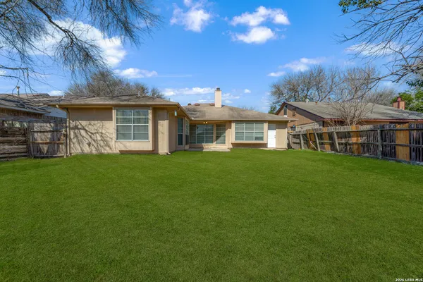 a view of a house with a yard and sitting area