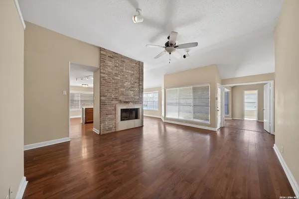 a view of a livingroom with wooden floor and ceiling fan