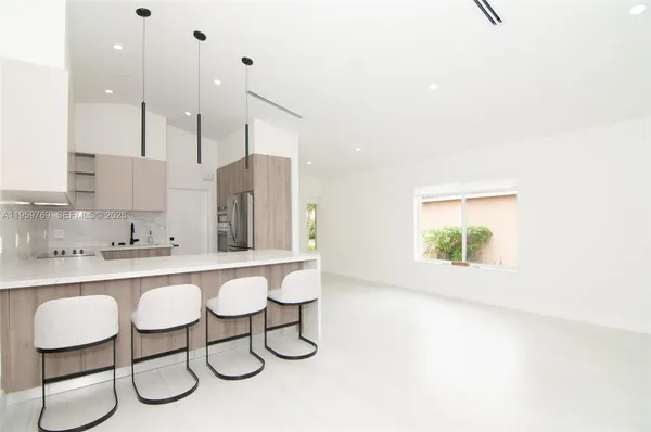 a kitchen with a table chairs stove and cabinets