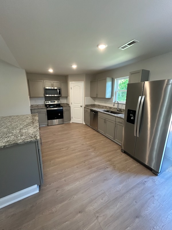 708 Hampton Street Iva, SC 29655 - Photo 6 of 14 This spacious kitchen offers ample counter space and modern appliances, perfect for everyday living.