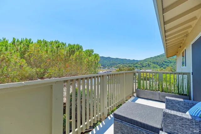 a view of a balcony with lake view and wooden floor