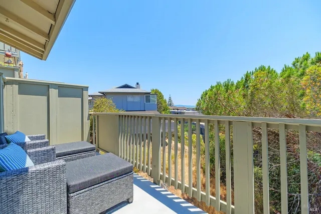 a living room with furniture a window and a table