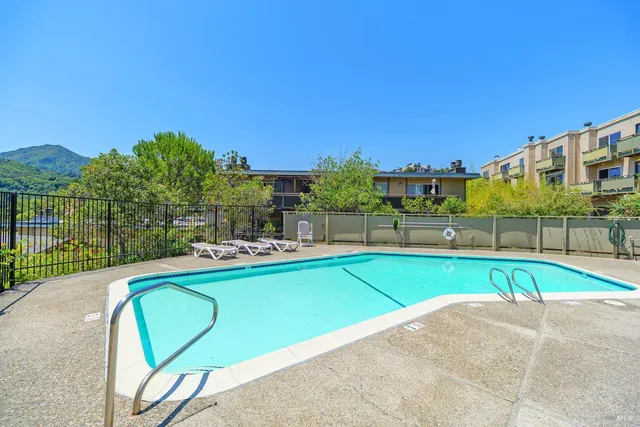 a view of a swimming pool with a lounge chairs