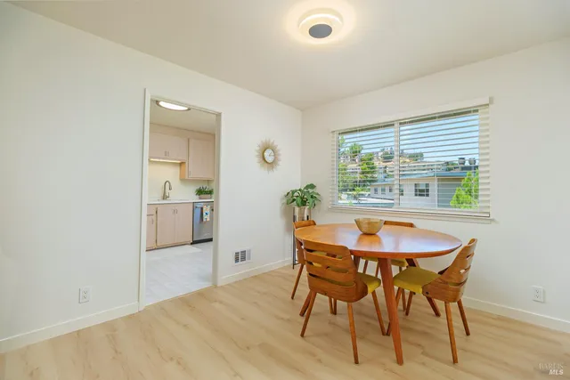 a view of a dining room with furniture and window