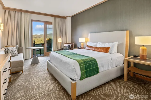 a bedroom with a large bed and a large window