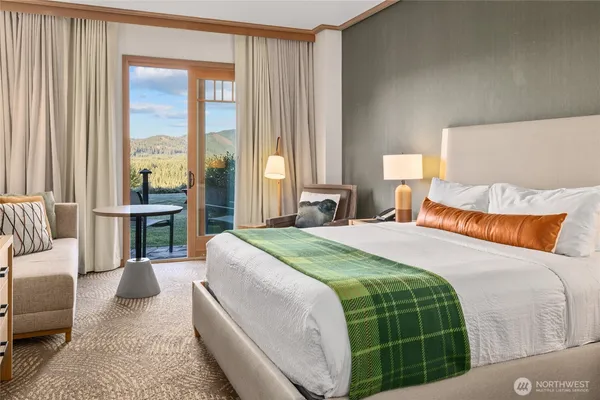 a bedroom with a large bed and a large window