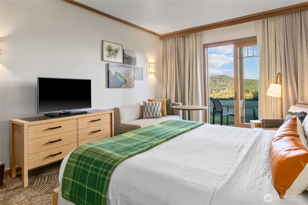 a bedroom with a bed and a flat screen tv