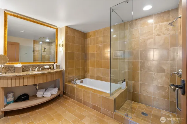 a bathroom with a granite countertop sink a shower and a mirror