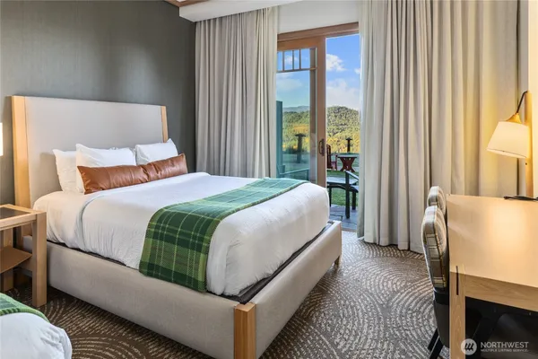 a bedroom with a bed a mirror and a window