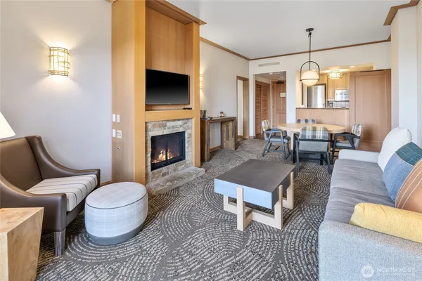 a living room with furniture a fireplace and a chandelier
