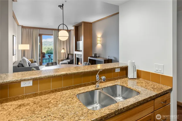 a bathroom with a granite countertop sink and a large mirror
