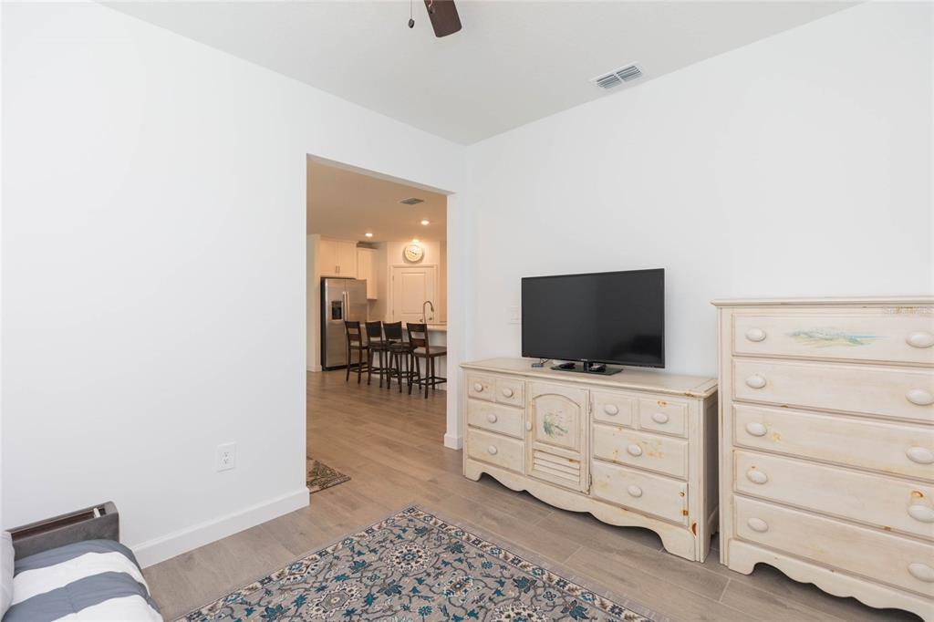 10806 Gable Dig Loop San Antonio, FL 33576 - Photo 14 of 73 a living room with furniture and a flat screen tv