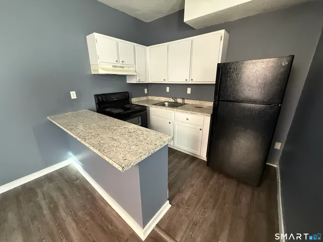 a kitchen with a refrigerator and a sink