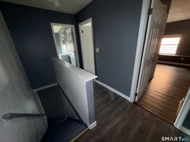 a view of entryway and hall with wooden floor