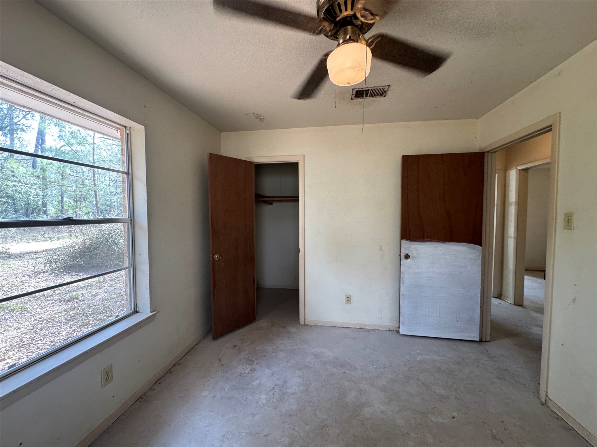 317 Bob Wills Road Livingston, TX 77351 - Photo 9 of 24 a view of an empty room with a window
