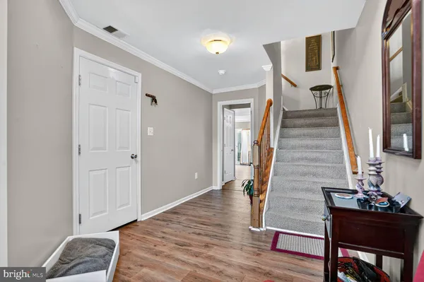 a view of a livingroom with wooden floor and stairs