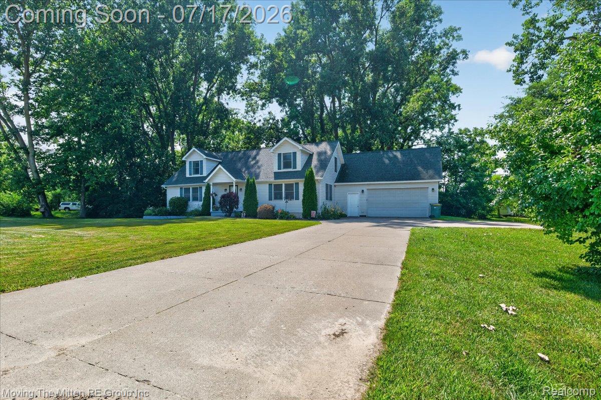 40162 Alden Road Belleville, MI 48111 - Photo 3 of 67 Dormered home featuring a two-car garage, concrete driveway, and established landscaping