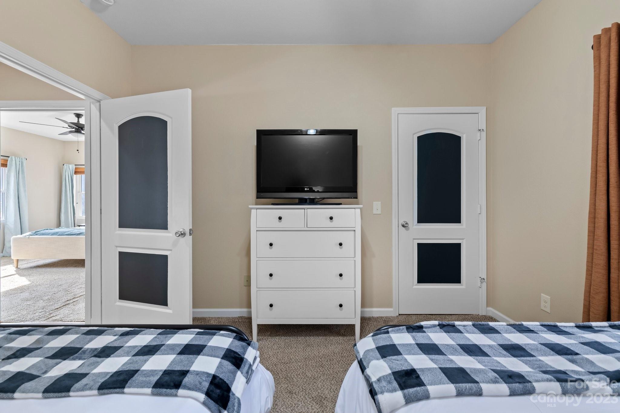 174 Diamond Point Canton, NC 28716 - Photo 17 of 43 a bedroom with a bed and a flat screen tv
