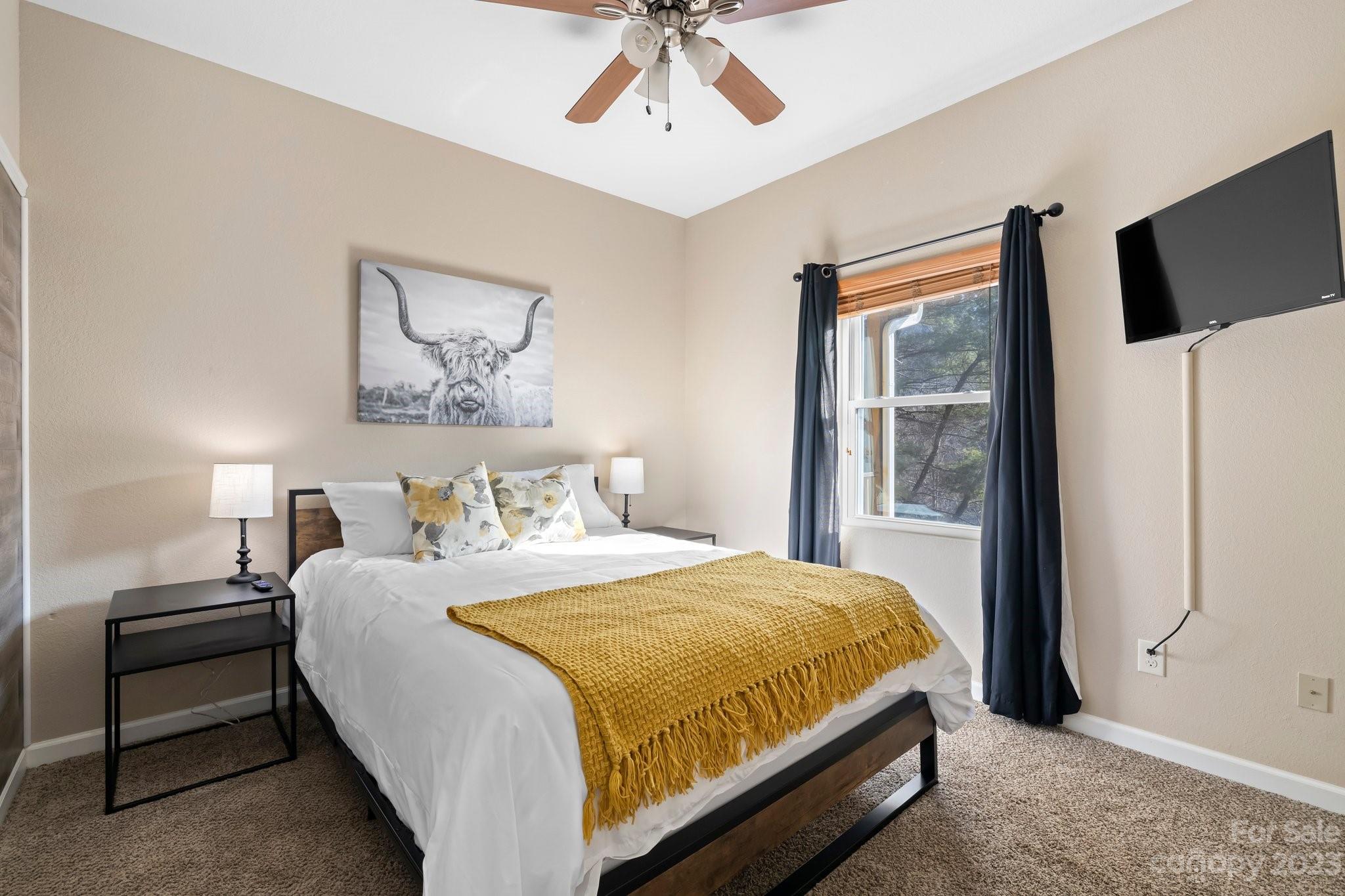 174 Diamond Point Canton, NC 28716 - Photo 20 of 43 a bedroom with a bed and a flat screen tv